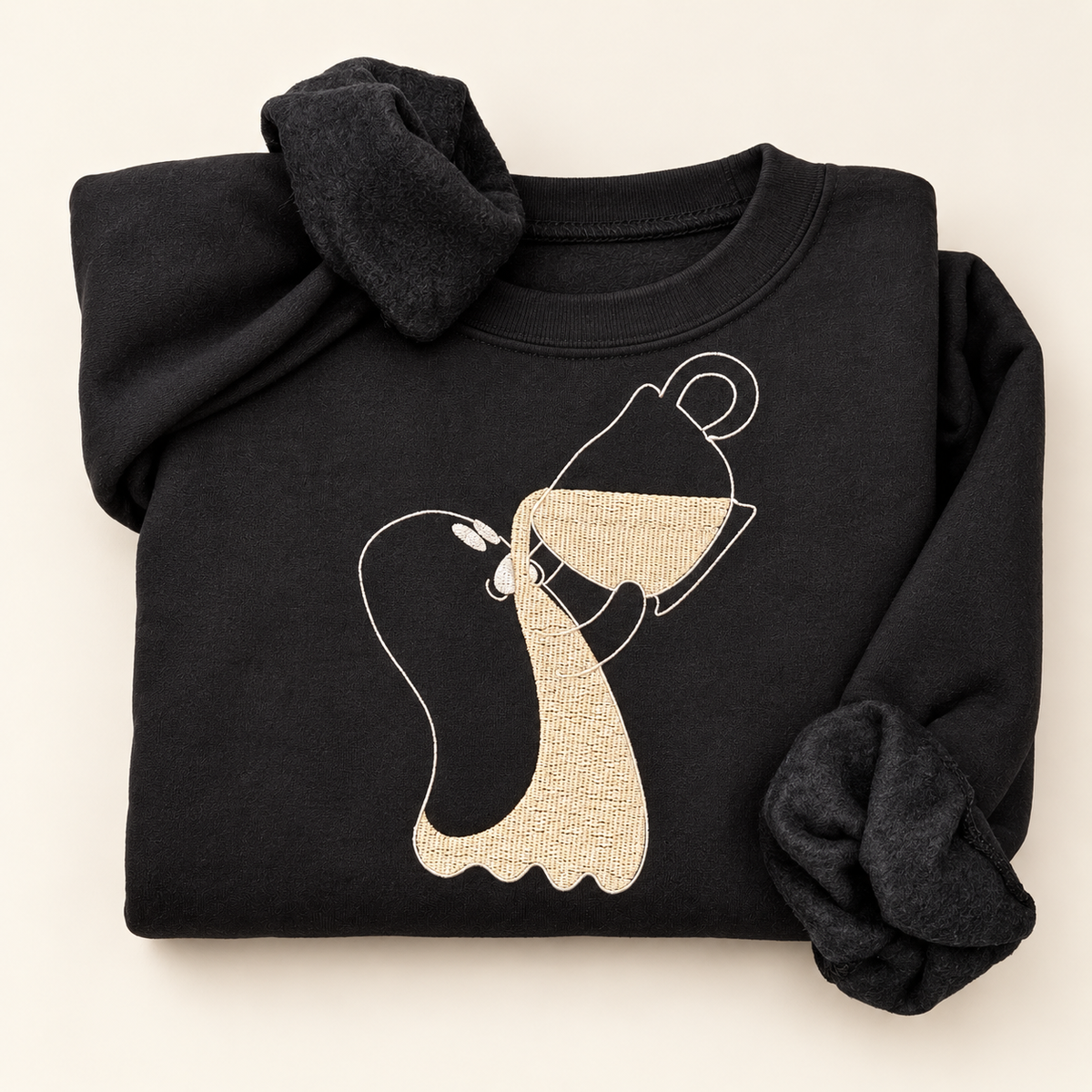 Black sweatshirt with a ghost holding a tipped coffee cup, embroidered in cream and white