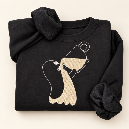 Black sweatshirt with a ghost holding a tipped coffee cup, embroidered in cream and white