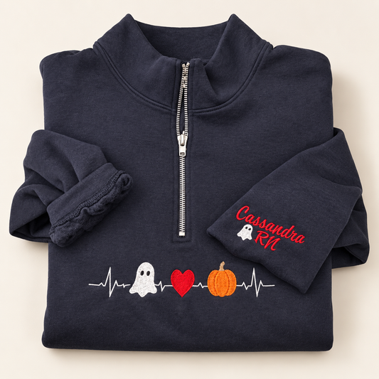 Navy quarter-zip with embroidered Halloween heartbeat, ghost, red heart and pumpkin, and Cassandra RN sleeve detail